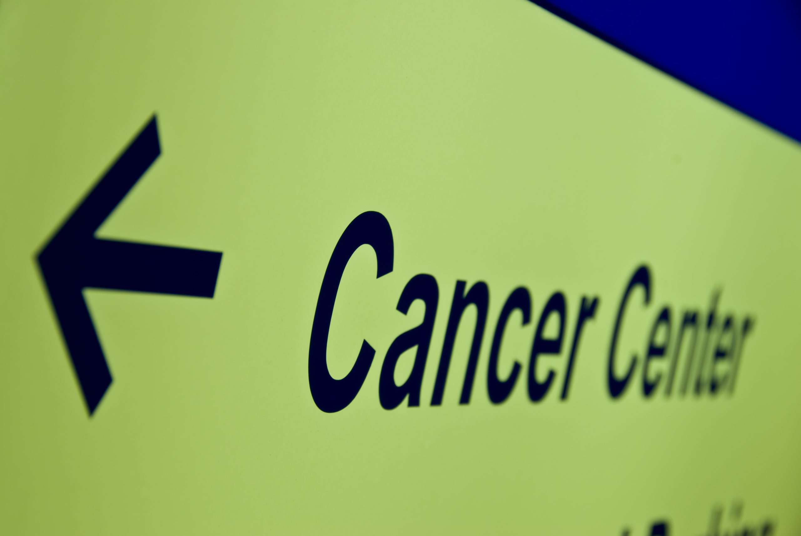 sign reading cancer center with an arrow pointing left